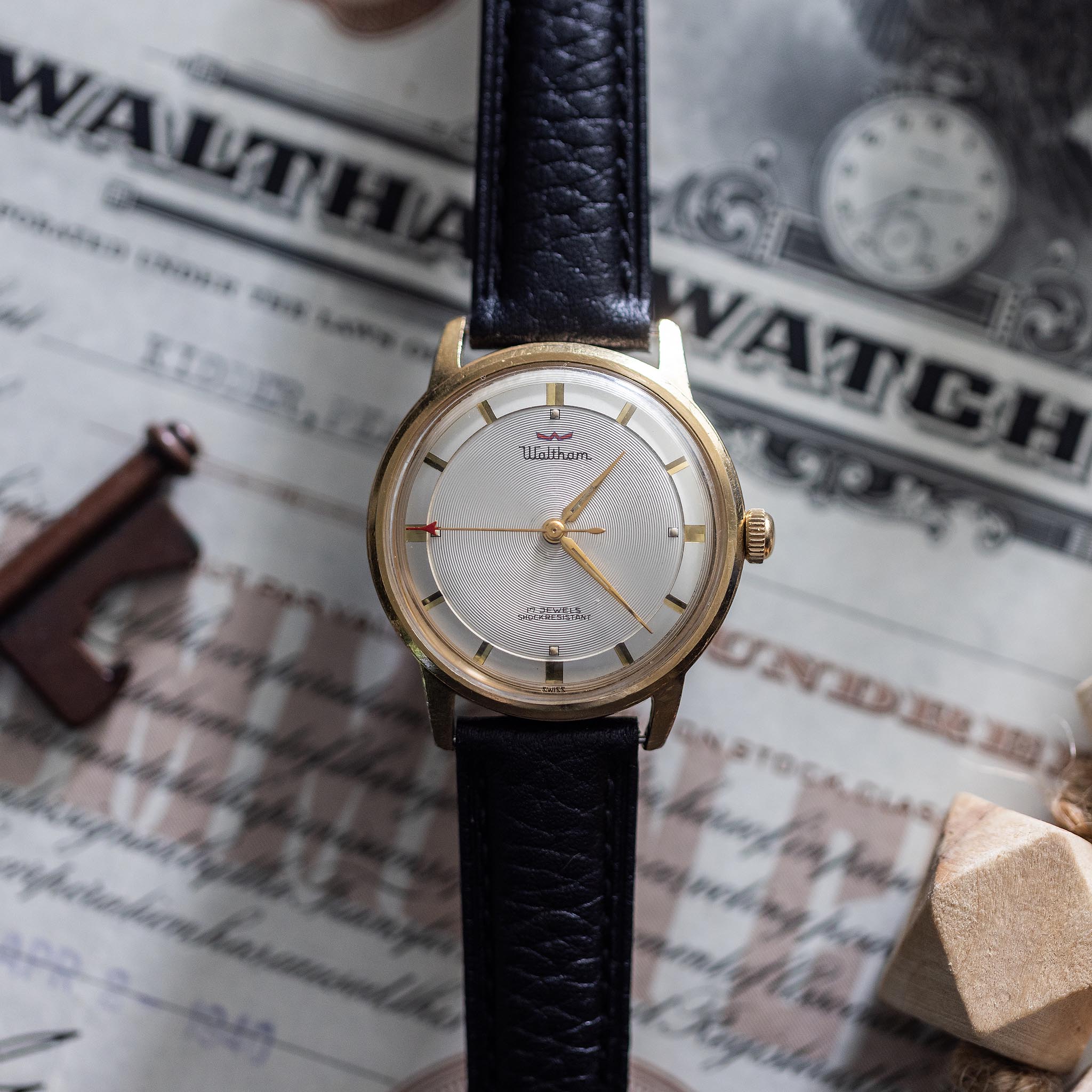 Restored vintage Waltham 17-jewel manual-wind wristwatch displayed with historical Waltham material.
