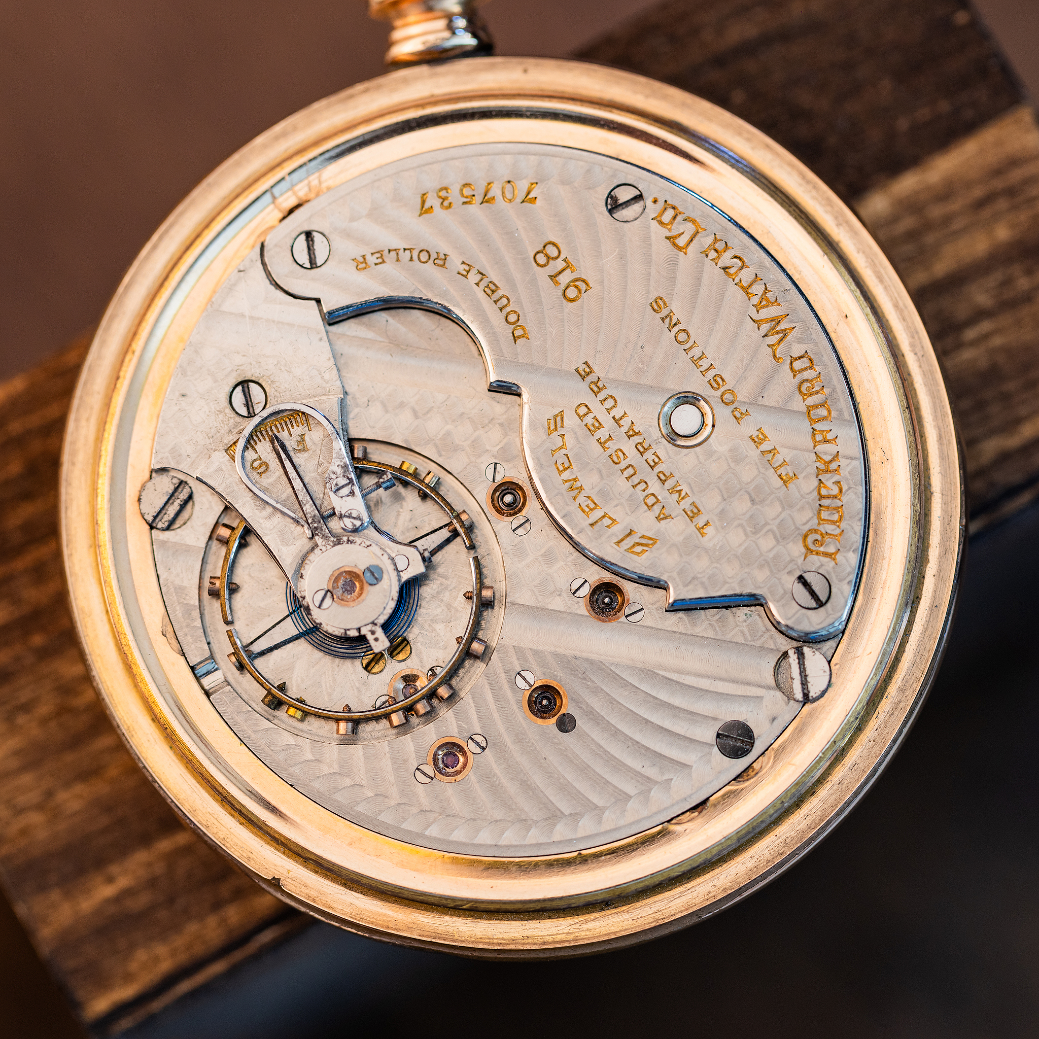 Intricate nickel damaskeening on a Rockford Grade 918 21-jewel American pocket-watch movement, with gold-tone lettering and exposed regulating assembly