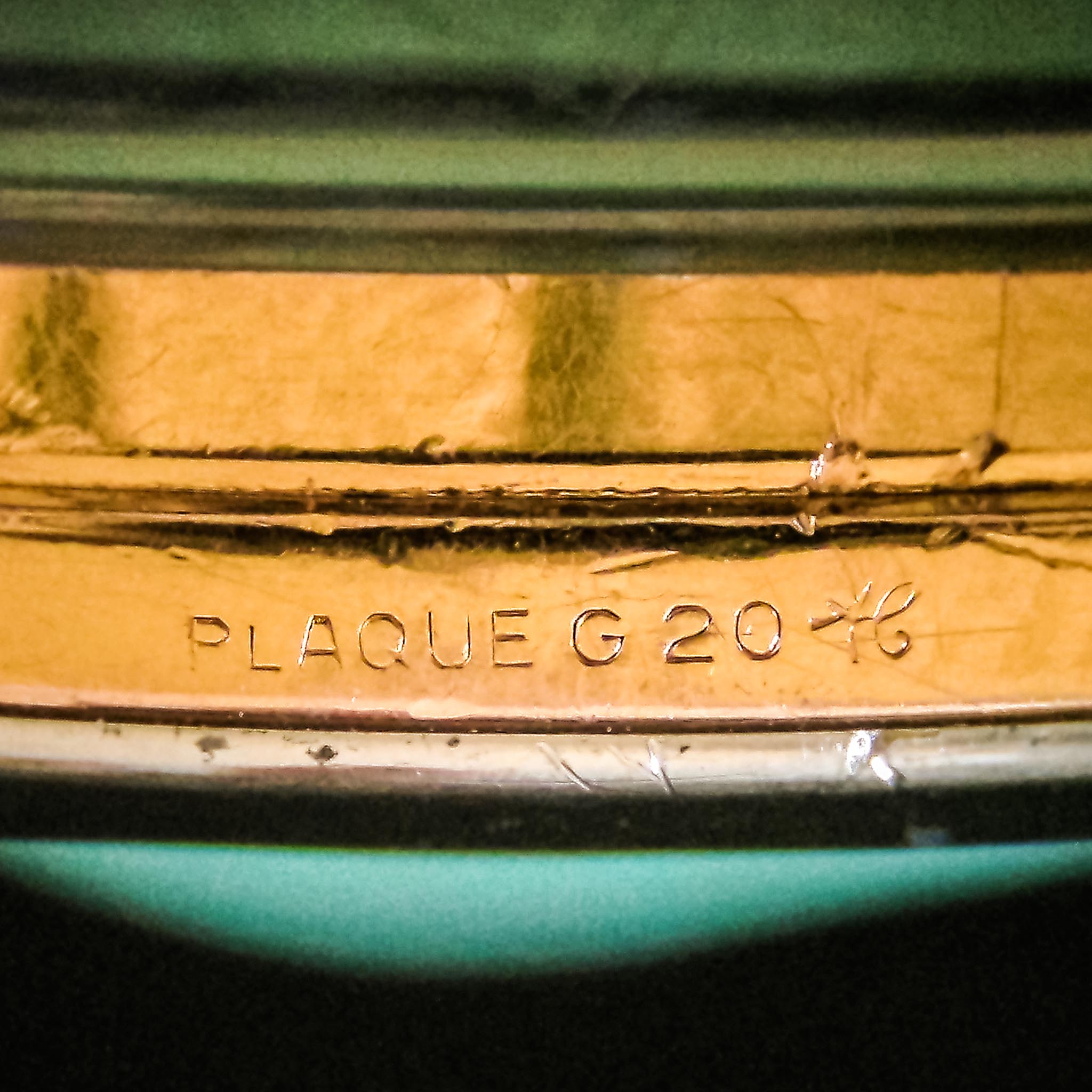 Macro image of PLAQUE G 20 gold-plating stamp on the side of a 1950s Breitling ref 1351 case.