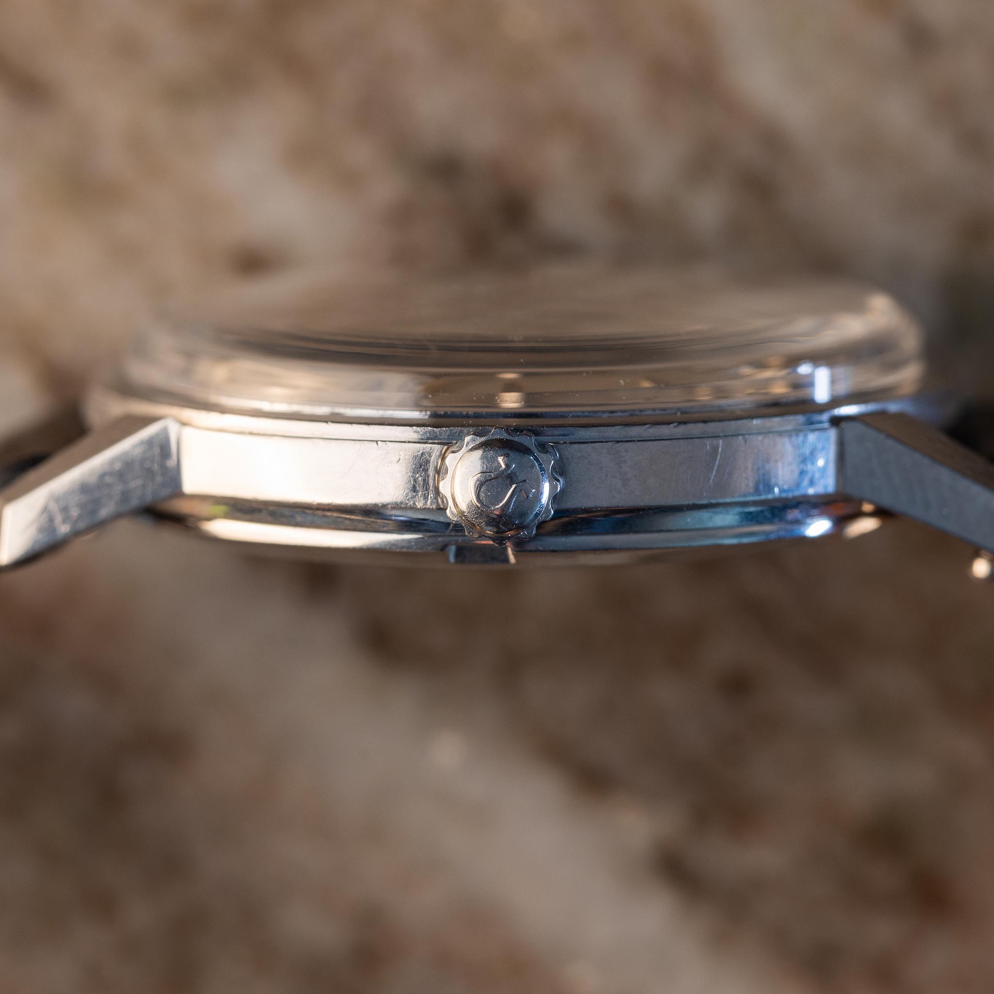 Side view of the Omega Seamaster Türler reference 165.002 showing the crown, stainless-steel case profile and lugs.