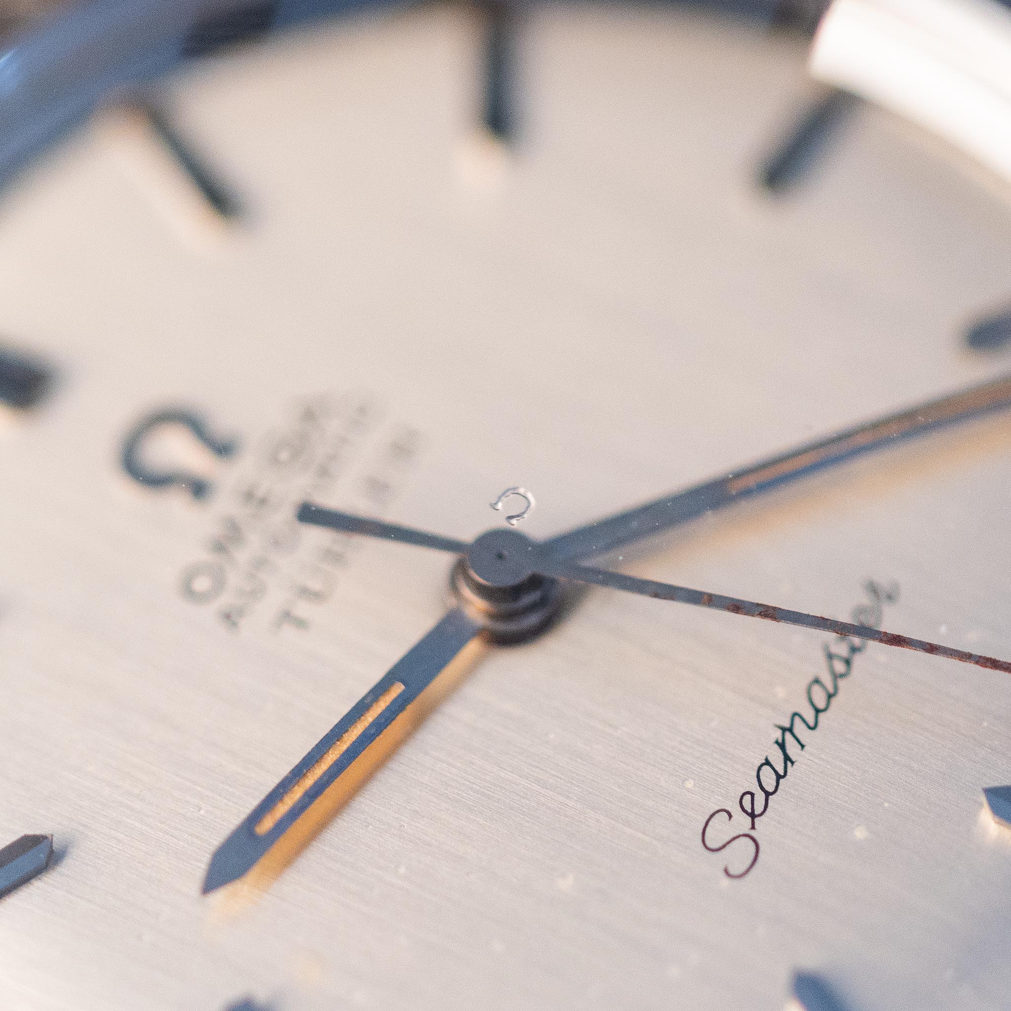 Close-up of the Omega Seamaster Türler dial showing the hands, baton markers, minute track and Seamaster script.