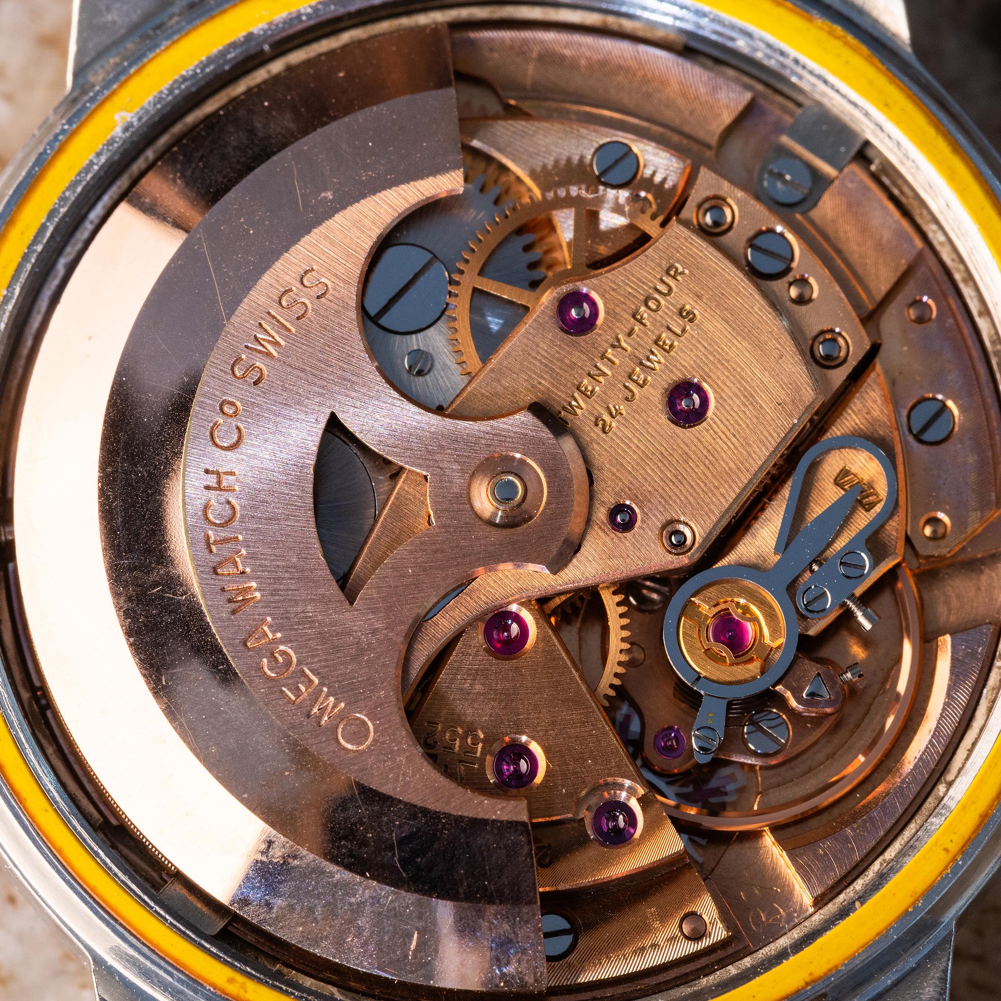 Full view of the copper-toned Omega caliber 552 automatic movement inside Seamaster reference 165.002.